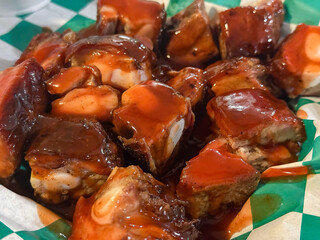 Rib Tips Closeup In Barbecue Sauce On Green And White Checkered Waxed Paper