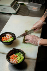 Sushi Chef Preparing Fresh Poke Bowls in a Professional Kitchen