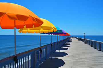 Tropical vacation scene featuring a row of colorful umbrellas on a seaside boardwalk with a calm blue ocean