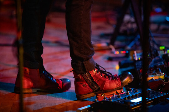 The Footwear of Musicians on Stage, Enhanced by Vibrant Effects Pedals for a Spectacular Show