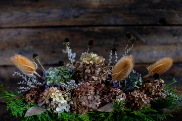 A Charming and Beautiful Dried Floral Arrangement Set Against a Rustic Background Setting