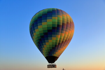 A colorful hot balloon view at sunrise. A hot balloon rising into the sky in the Cappadocia region. Turkey