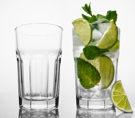 Mojito refreshing summer drink with ice and mint, lime and alcohol. Non-alcoholic mojito, isolated on white