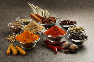 Various spices in a bowls on stone background. Mix spices Indian spices food and cuisine ingredients