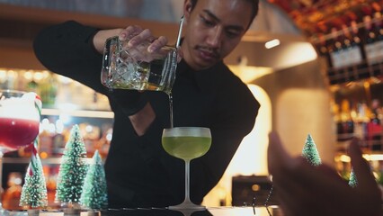 Bartender preparing to serve Midori sour with lime syrup pouring into saucer glass. Focusing special refresh japanese liqueur drink style showcasing nightlife mixology at nightclub luxury. Vinosity.