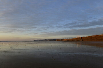 St.Ouen's Bay, Jersey, U.K. Natural Winter beach at sunset with 19th century White guardhouse.