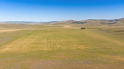 Fototapeta premium Farmland Tractor Landscape Under Blue Sky
