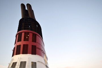 Obraz premium Diesel exhausts through the funnel of a modern cruise ship