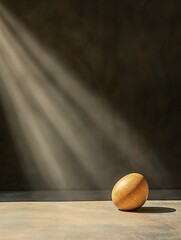 Stone illuminated by sun rays on a minimalist surface in a dark setting