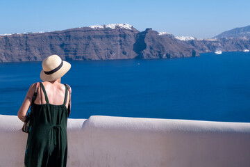 Woman looking at the Caldera in Oia, Santorini