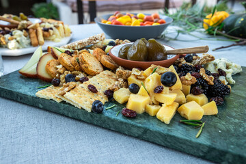 Appetizers with cheese, crackers, olives and fruits