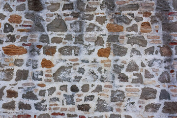 Old stone wall with white plaster
