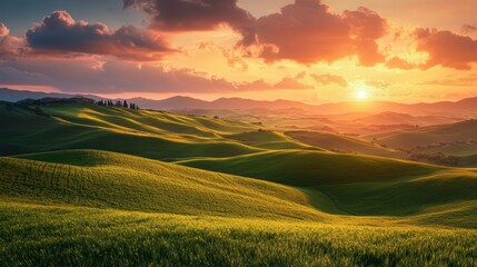 Obraz premium National Geographic Rolling green hills under a sky painted with warm hues of sunset.