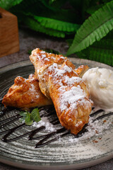 Golden Puff Pastry Dessert with Powdered Sugar and Ice Cream