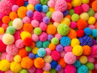 A vibrant array of colorful pompoms in various shades, creating a playful and cheerful craft display.