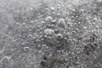 Bubbles of air frozen in river water flat lay