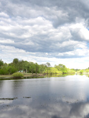 Calm lake with a cloudy sky in the background