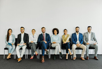 man business chair sitting waiting businessman candidate recruitment office businesswoman woman businessperson job young interview line employee career row hall colleague