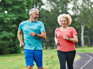woman mature man outdoor running couple sport together jogging healthy mid adult nature fit active exercise fitness run park middle age