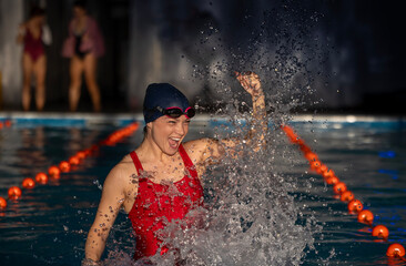 Swimmer woman celebrates victory after a challenging race in the pool