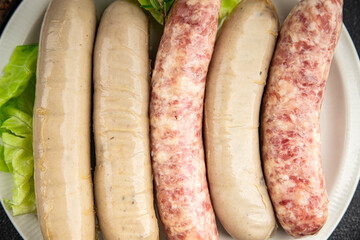 raw sausages pork, beef, chicken, fresh tasty food dish gourmet food background on the table rustic...