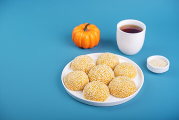 Pumpkin sesame seeds balls in a plate with tea