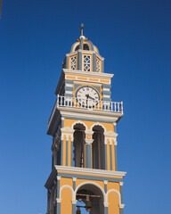 Blue and yellow clock tower in Santorini