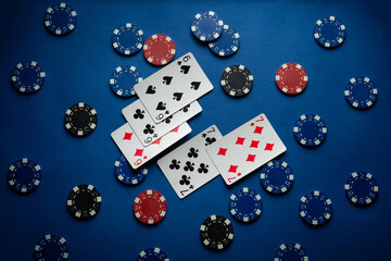Blue table in a poker club with a combination of winning playing cards full house or full boat and chips. Gambling inspires a good money win