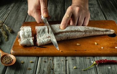 A skilled chef expertly slices fresh fish on a wooden cutting board, surrounded by aromatic spices...