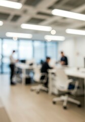 A spacious office with professionals engaged in work, captured with a blurred depth-of-field effect.