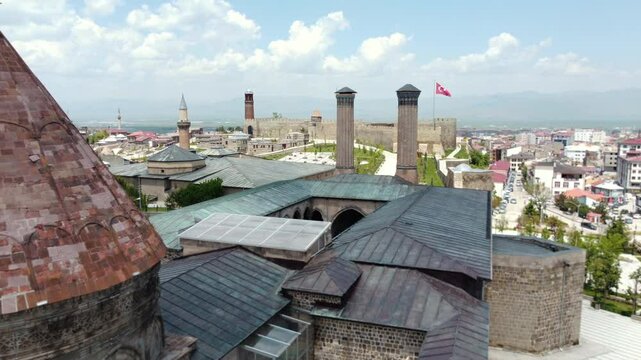 An impressive drone shot reflecting the historical silhouette of Erzurum. A fascinating view where the Twin Minaret Madrasa, the Ulu Mosque minaret, Erzurum Castle and Tepsi Minaret are intertwined.