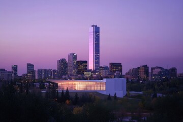 Fototapeta premium Aerial view of a city at sunset, with buildings and cars visible