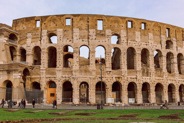 Naklejka premium Panoramic view of old Colosseum in Rome. Beautiful popular of ancient landmark. Famous card of city of Rome, Italy. High quality photo