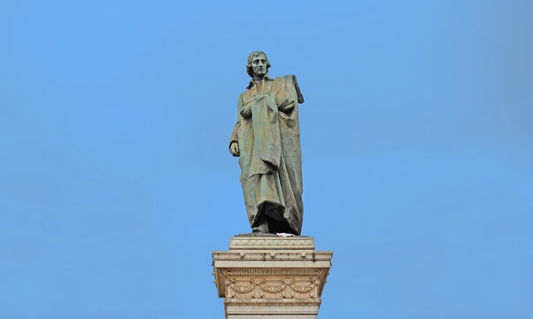 Bronze statue of the writer and poet Giuseppe Parini in Via Dante with blue sky in Milan, Italy