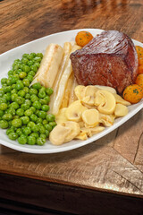 Tornedor Luiz XV, classic French dish, with tall fillet, mushrooms, peas and soutee potatoes