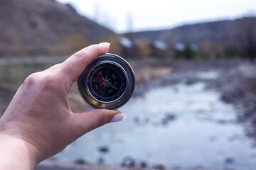 compass in man hand nature background