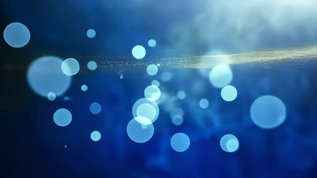 An abstract background featuring a soft blue hue with glowing light bokeh effects, creating a dreamy, peaceful atmosphere.
