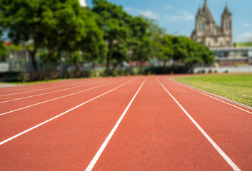 A track with white lines and a red background