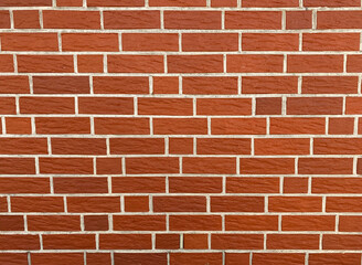 The bricks are arranged in a horizontal pattern, with each brick slightly overlapping the one below it. The color of the bricks is a deep, rich red, with some areas appearing lighter and others darker