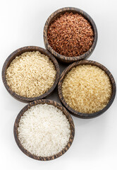 different kinds of asian rice grains in bowls on white background