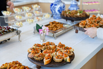 catering buffet with different food snacks and appetizers on table