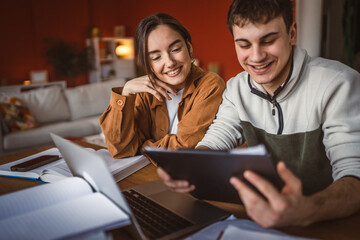 young man and woman student study and research on laptop at home