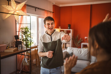 boyfriend dance energetically with his girlfriend at home