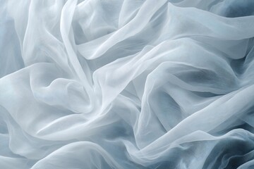 Fototapeta premium Draped light blue sheer fabric with soft folds and wrinkles.