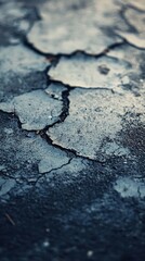 Obraz premium Cracked asphalt surface exhibiting deterioration and weathering damage