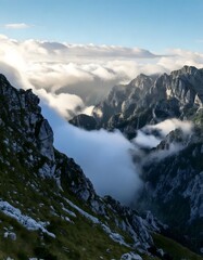 A beautiful mountain landscape covered in low clouds, evoking mystery and tranquility.