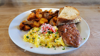 Scrambled eggs, home fries, toast and homemade sausage