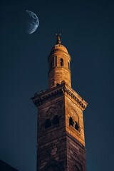 Fototapeta premium Stunning islamic mosque building architecture photography showcasing a minaret and the glowing moon.
