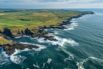 Aerial view of rugged coastal cliffs with ocean waves crashing against the shoreline