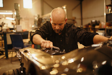 Middle aged caucasian mechanic working in a mechanics shop